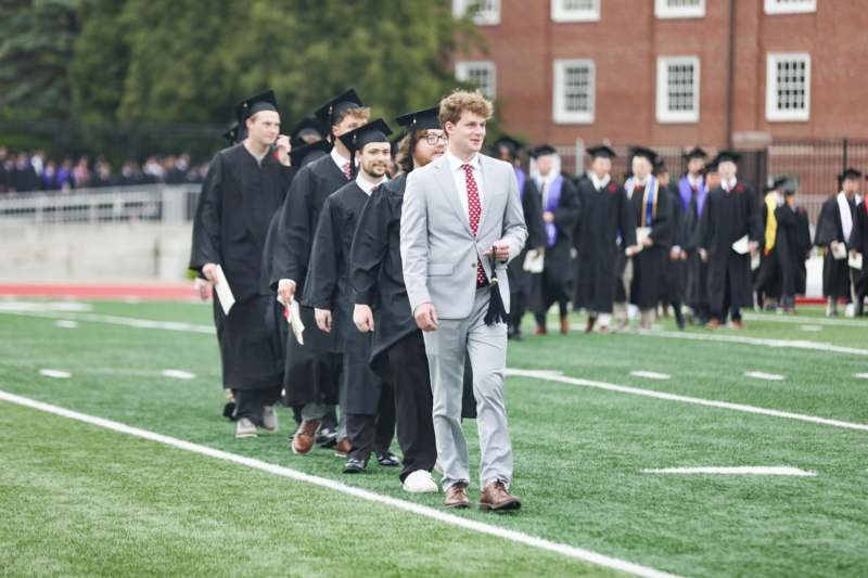 a group of people walking on a field