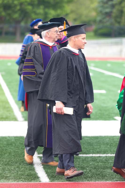 a group of men in graduation gowns