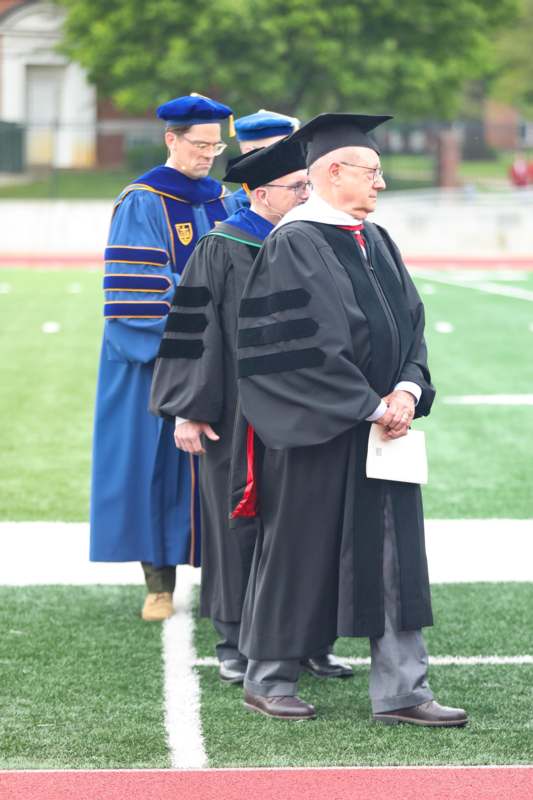 a group of men in graduation gowns