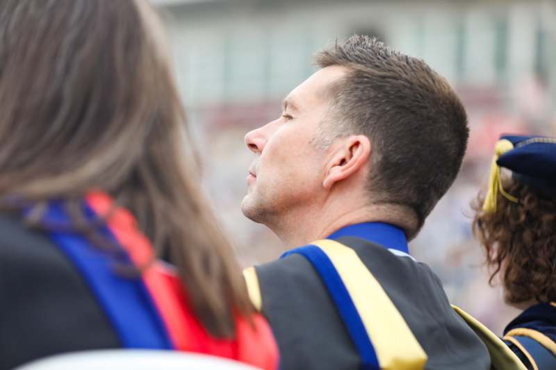 a man looking away from another man