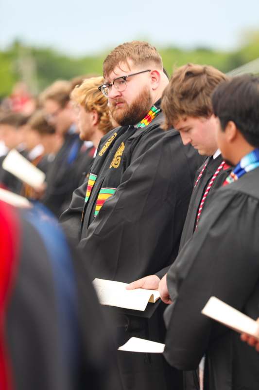 a group of people in black robes