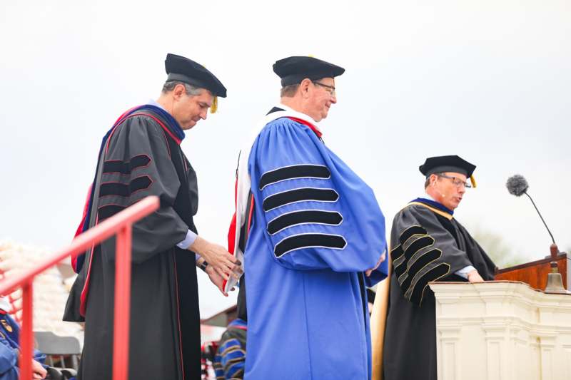 a group of men wearing graduation gowns