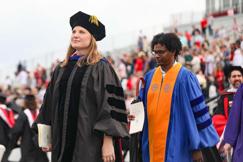 a woman in graduation gowns and cap