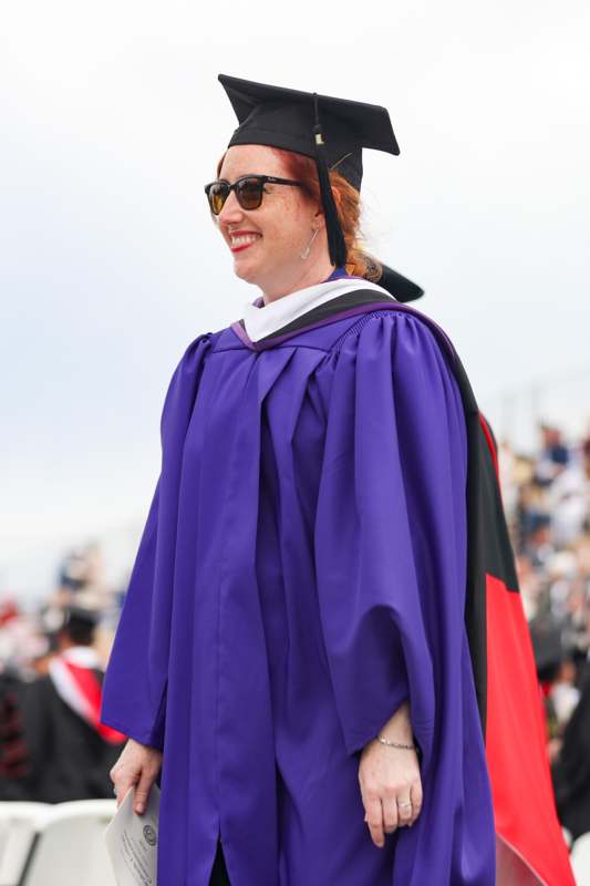 a woman wearing a graduation gown and cap