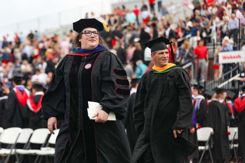 a woman in a graduation gown and cap