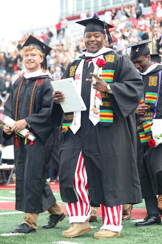 a group of men in graduation gowns
