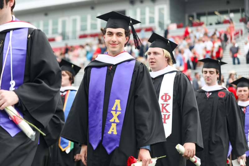 a group of people wearing graduation gowns and caps