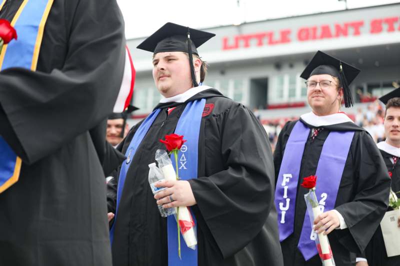 a group of people in graduation gowns and caps