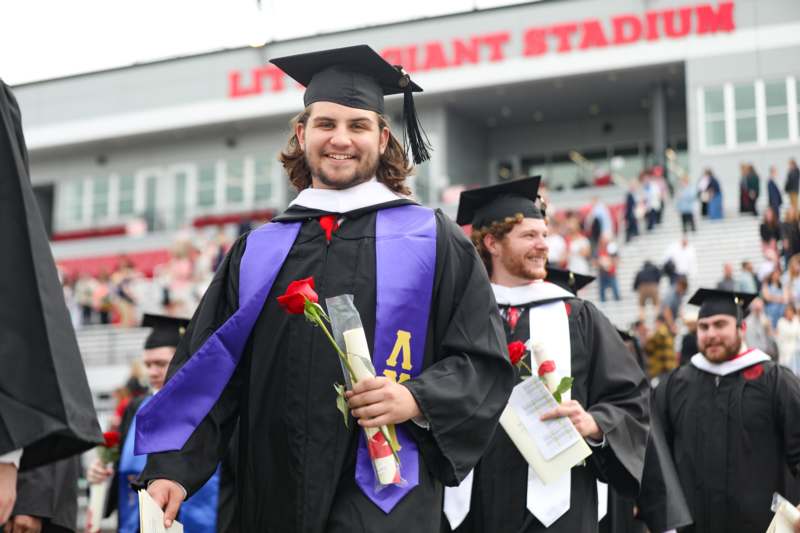 a group of men in graduation gowns and caps