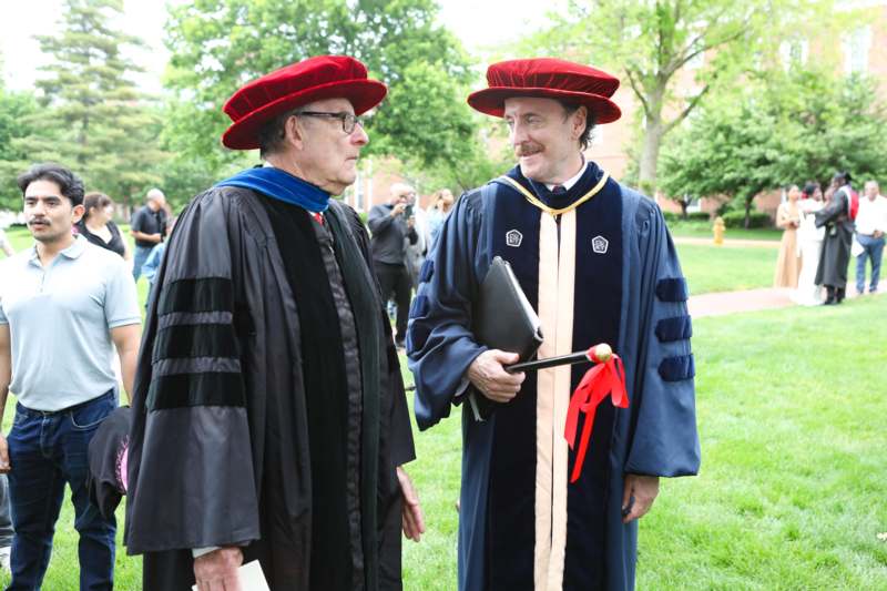 two men wearing hats and gowns