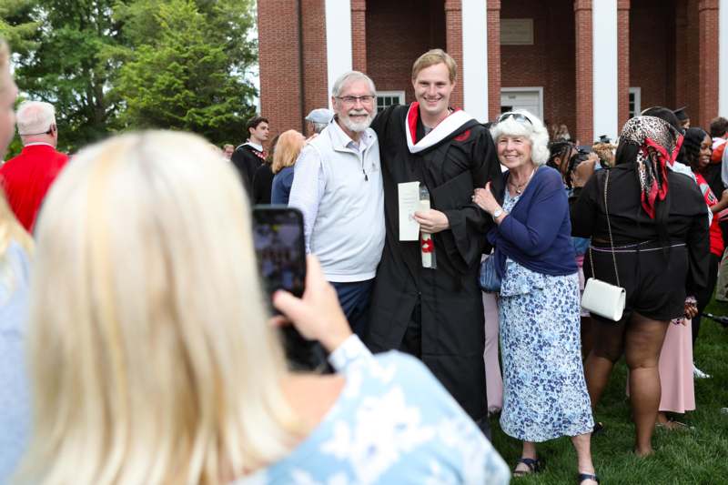 a man in a graduation gown with a man in a robe and a man in a robe