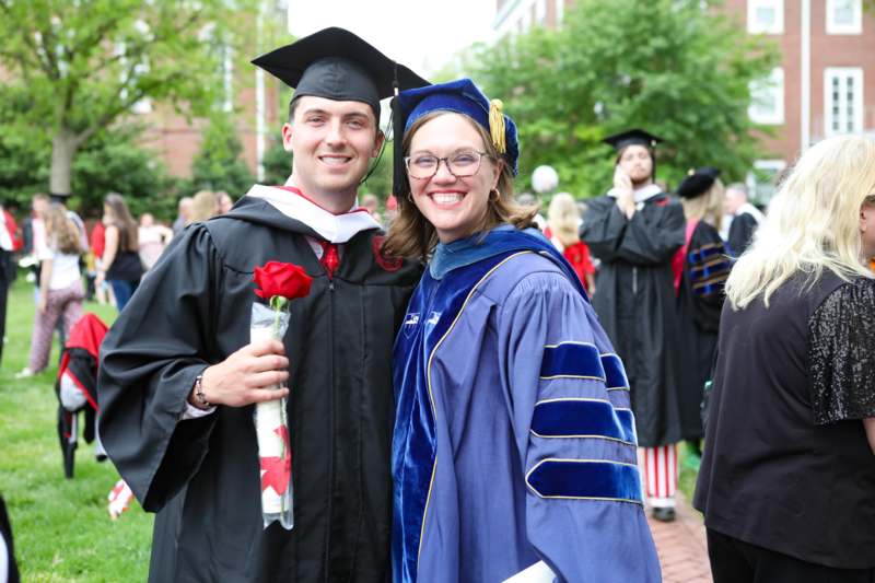 a man and woman in graduation gowns