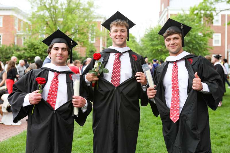 a group of men in graduation gowns and caps