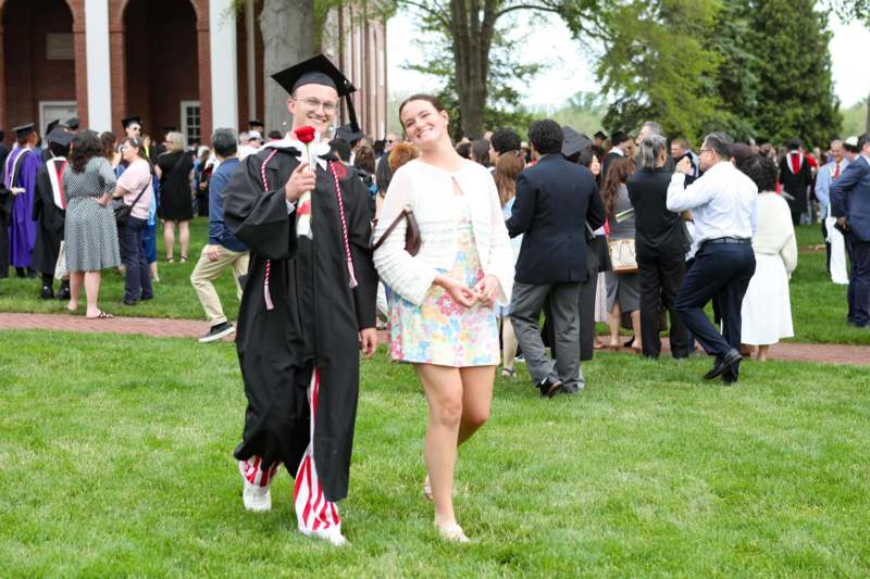 a man and woman in graduation gowns and cap and gowns