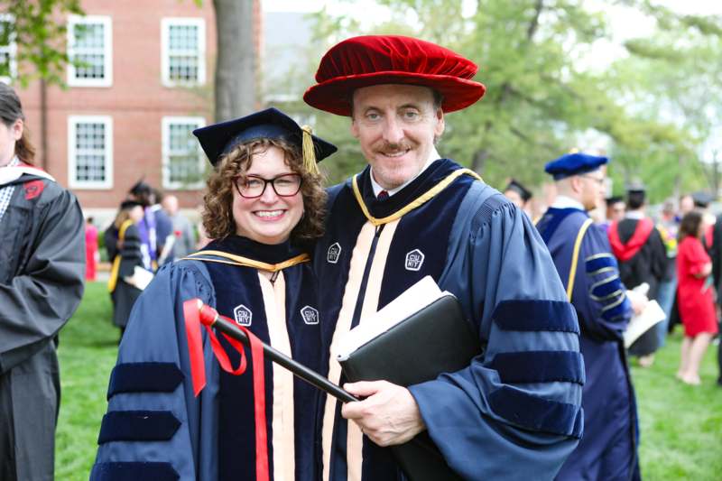 a man and woman in graduation gowns