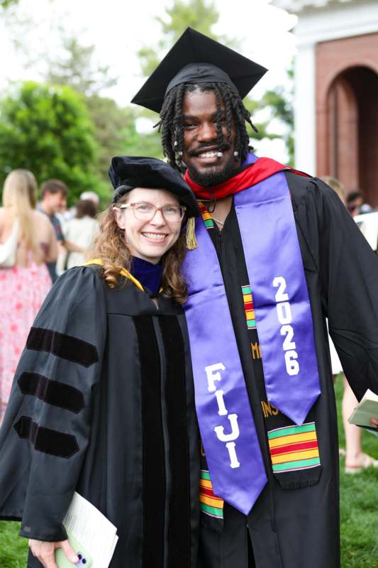 a man and woman in graduation gowns and cap and gown