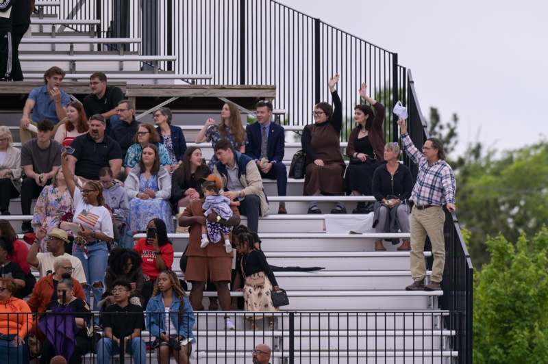 a group of people sitting on bleachers