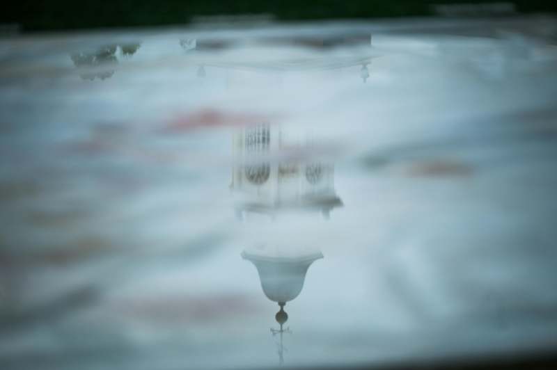 a reflection of a building in a puddle