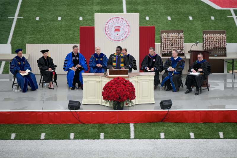 a group of men sitting at a podium