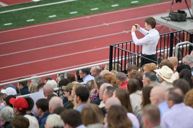 a man taking a picture of a crowd of people