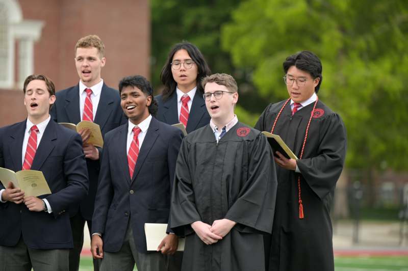 a group of men wearing suits and gowns
