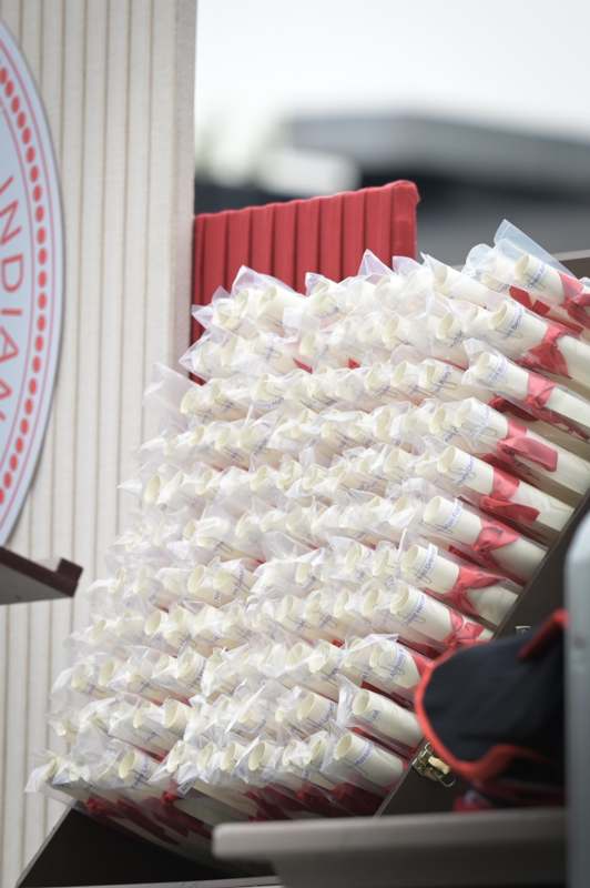 a group of white and red graduation caps