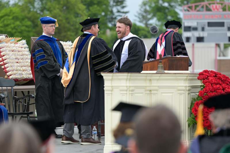 a group of men wearing graduation gowns and hats