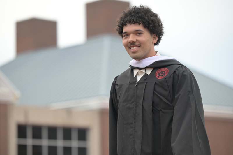 a man wearing a graduation gown