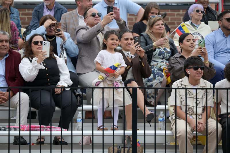 a group of people sitting on bleachers