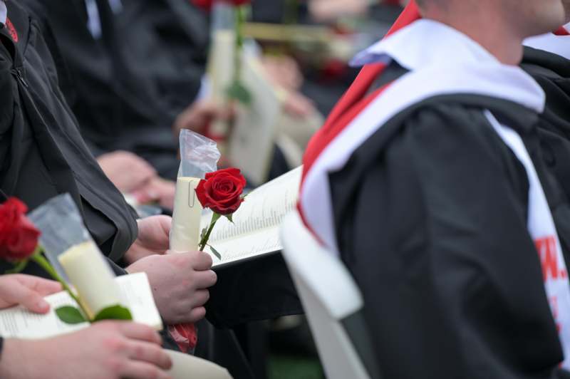 a person holding a rose and a book