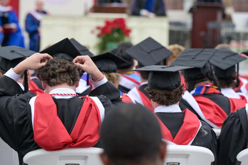 a group of people in graduation gowns and caps