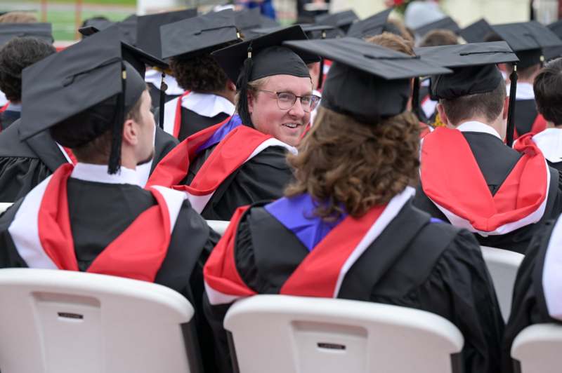 a group of people in graduation gowns and caps