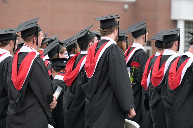 a group of people in graduation gowns and caps