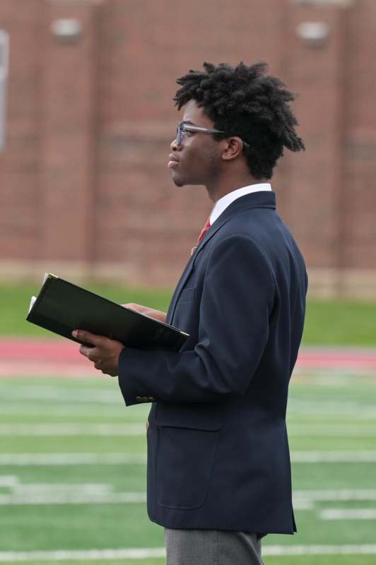 a man in a suit holding a book