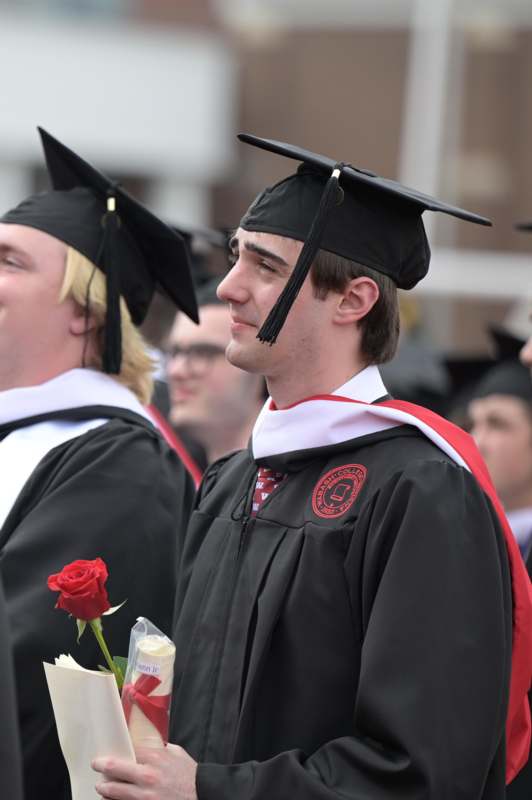 a man in a graduation gown and cap