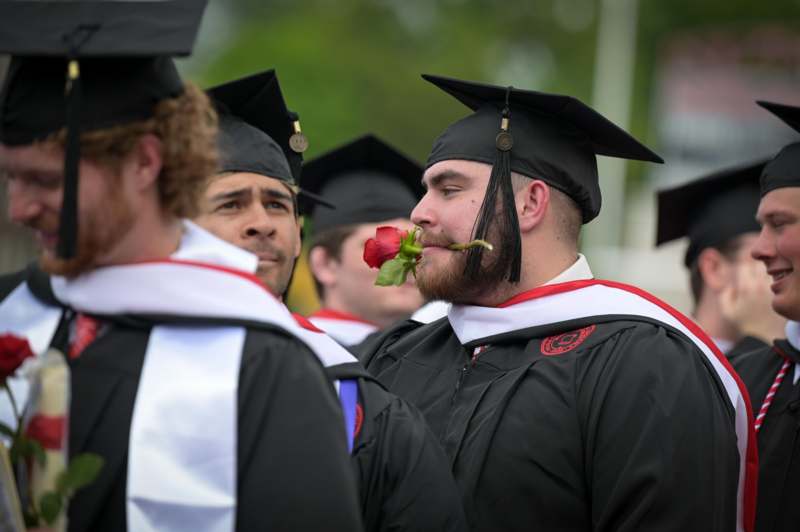 a group of people in graduation gowns and caps