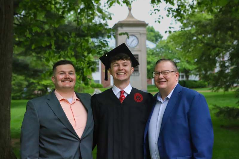 a group of men standing together and smiling