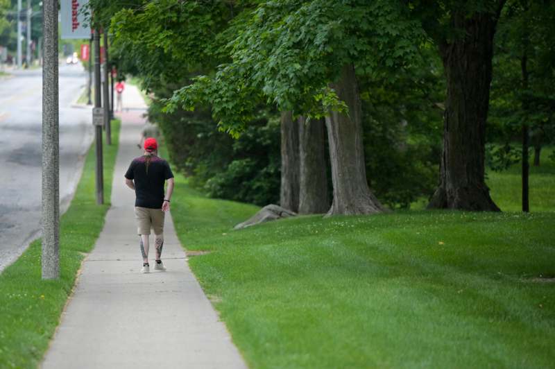 a man walking on a sidewalk