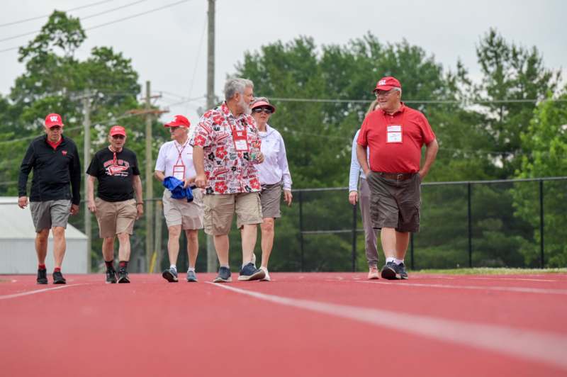 a group of people walking on a track