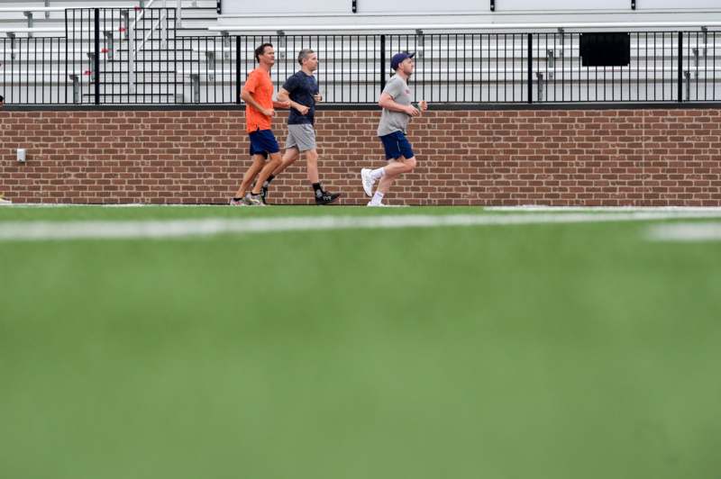 a group of men running on a field