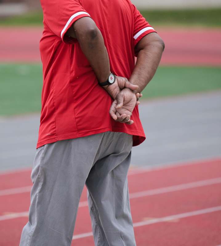 a man standing on a track with his hands behind his back