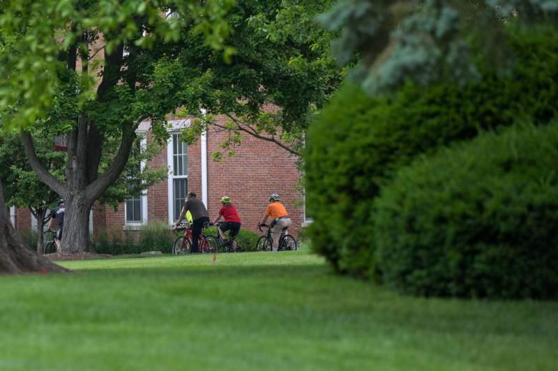 a group of people riding bicycles in a park