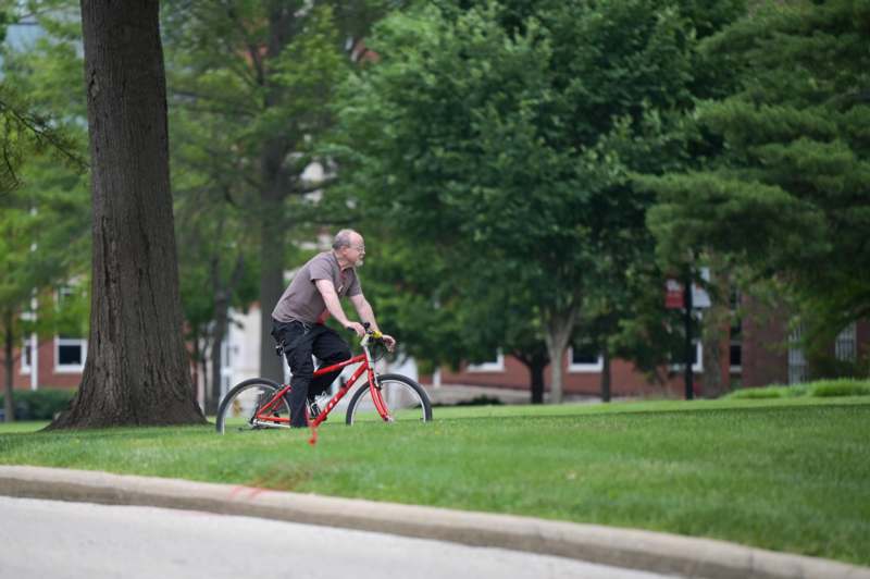 a man riding a bicycle in a park