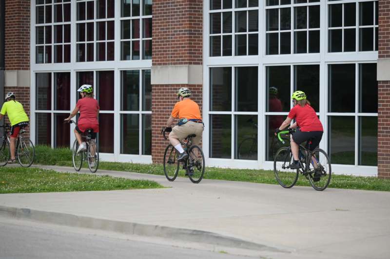 a group of people riding bicycles