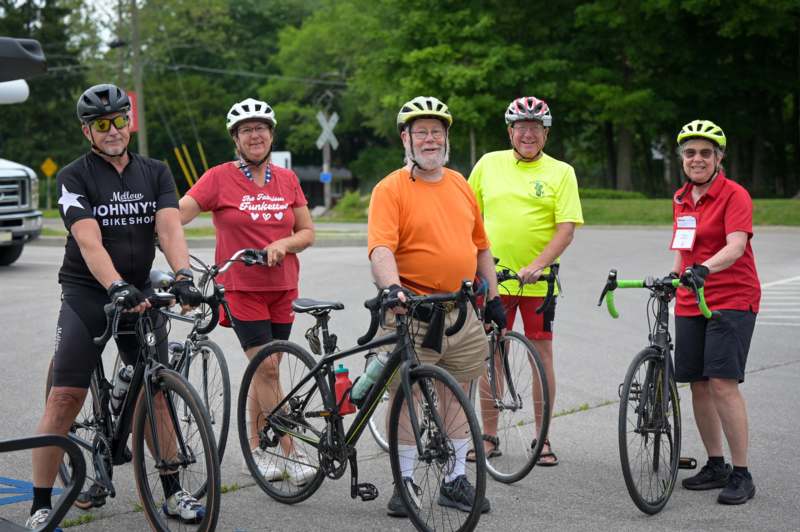 a group of people with bicycles