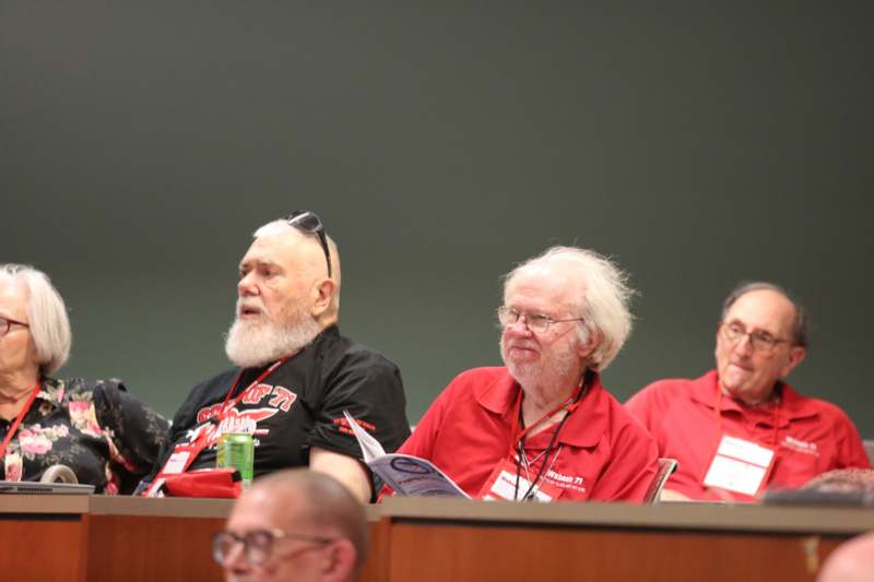 a group of men sitting at a table