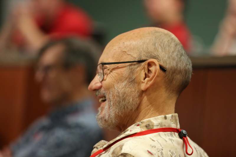 a man smiling with glasses