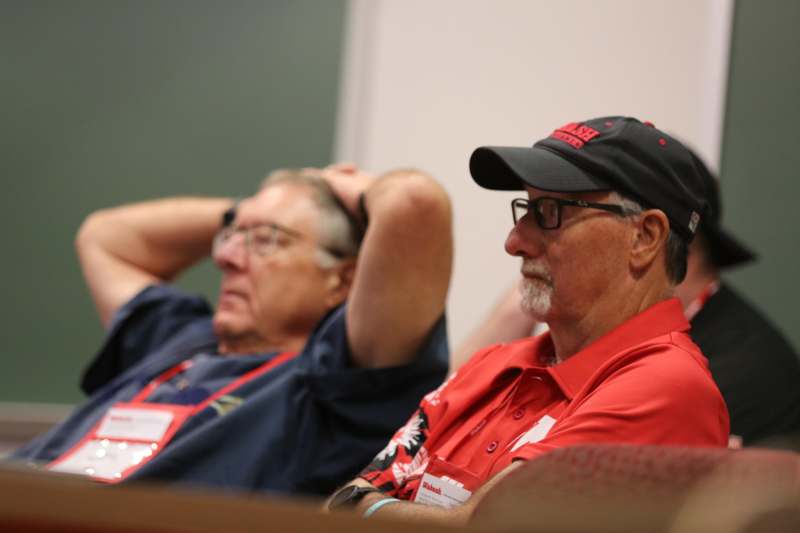 a group of men sitting in chairs