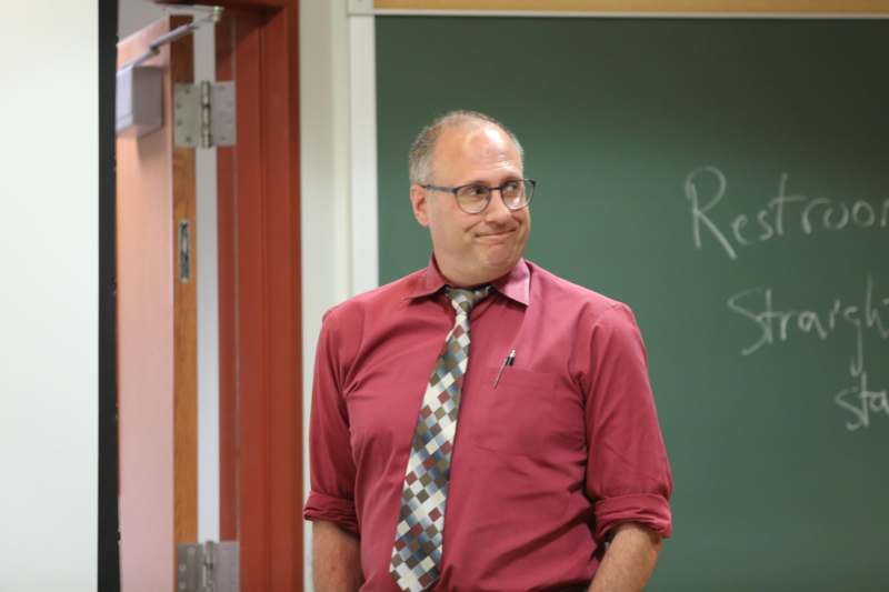 a man in a red shirt and tie