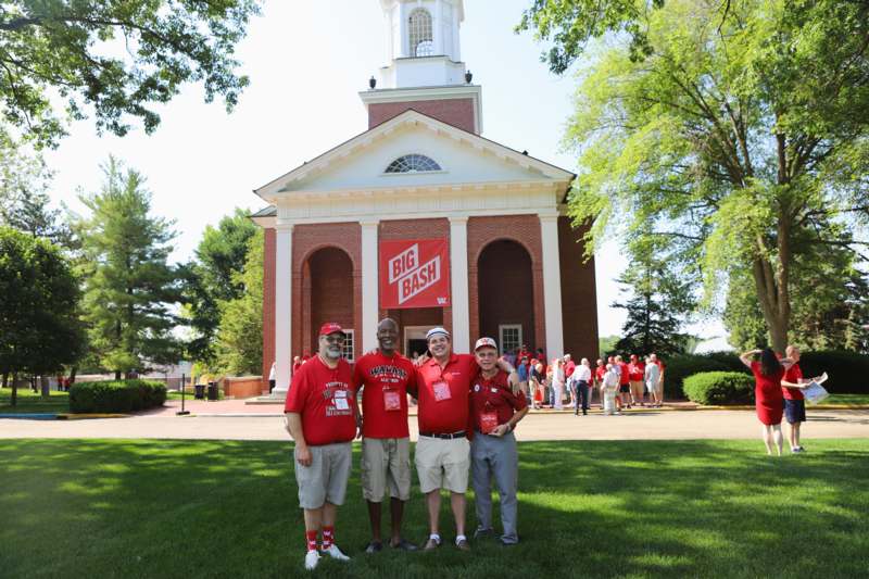 a group of men standing in front of a building